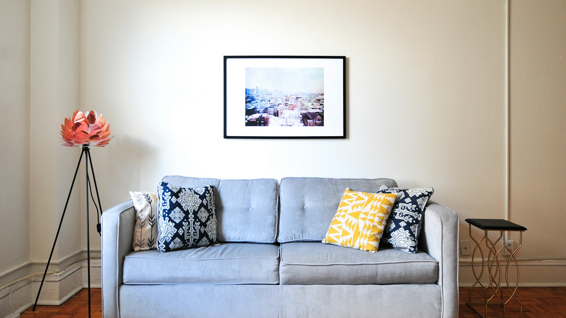 Minimal bedroom scene with layered bedding and side lighting